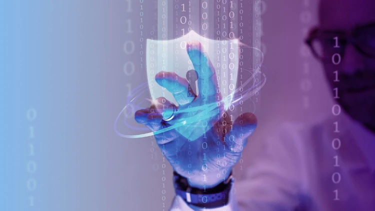 Close-up of a professional touching a holographic digital security shield, symbolizing cybersecurity.